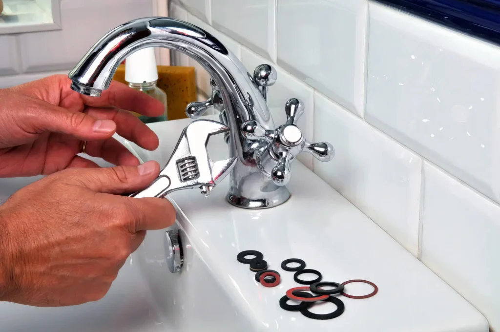 Plumber performing maintenance on a bathroom faucet in Melbourne