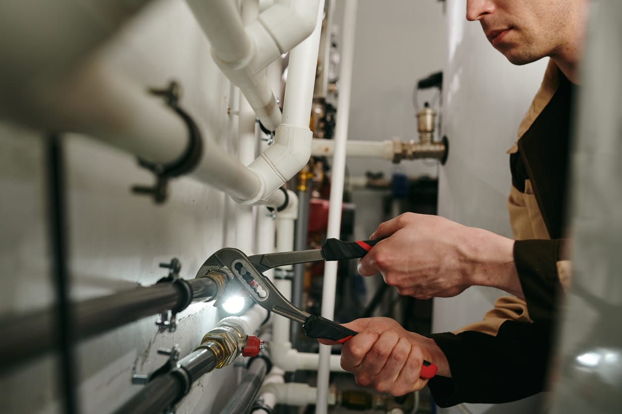Plumbers maintaining commercial plumbing pipes in Melbourne
