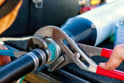 Technician tightening an industrial pipe connection in Melbourne