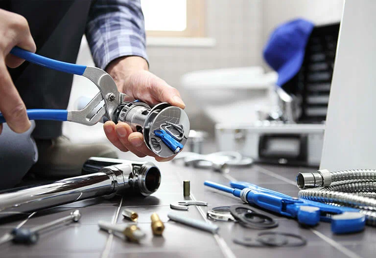 Technician repairing a plumbing fixture with professional tools in Melbourne