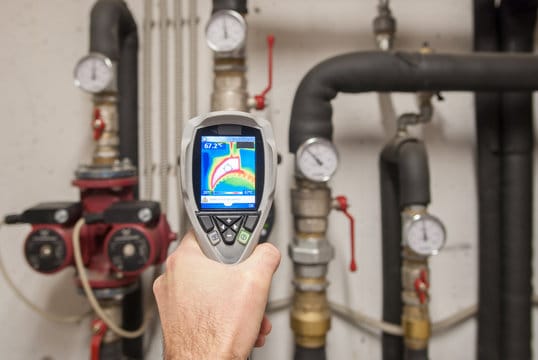 Plumber using a thermal imaging camera to inspect pipes in Melbourne
