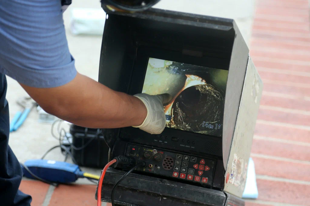 Technician viewing a drain inspection camera in Melbourne