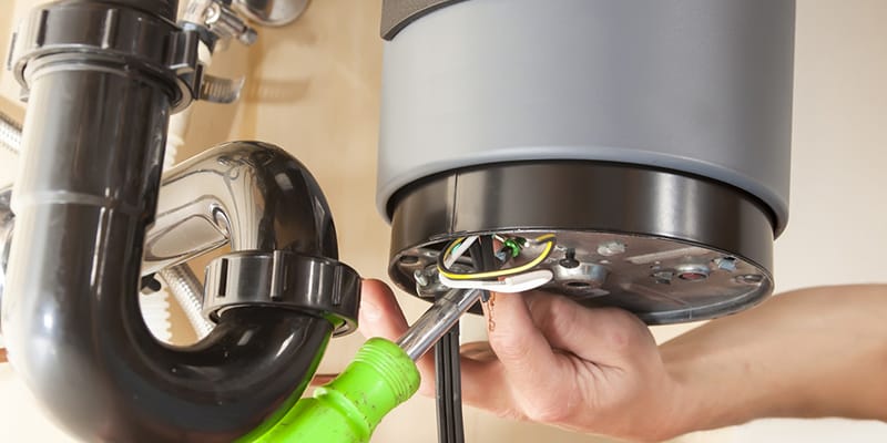 Technician repairing the heating element of a water heater in Melbourne