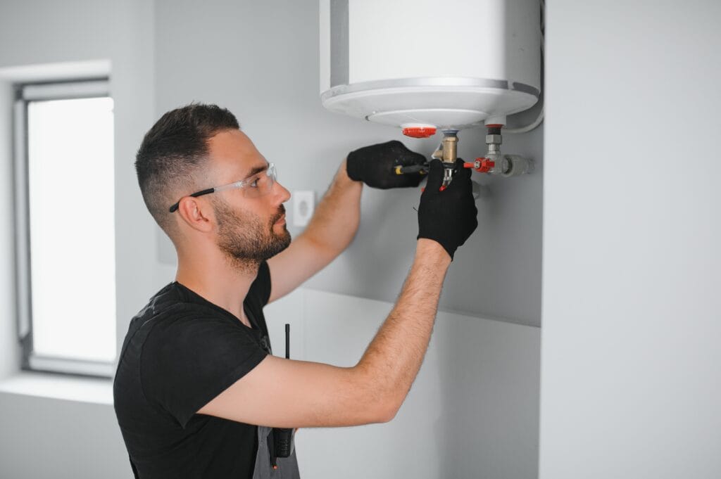 Technician performing water heater maintenance in Melbourne